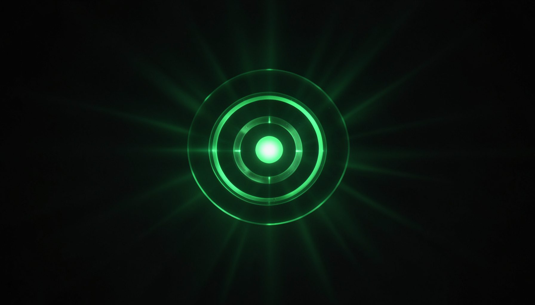 Dark atmospheric scene with a glowing green circular emblem at center, deep charcoal background with subtle emerald light rays radiating outward